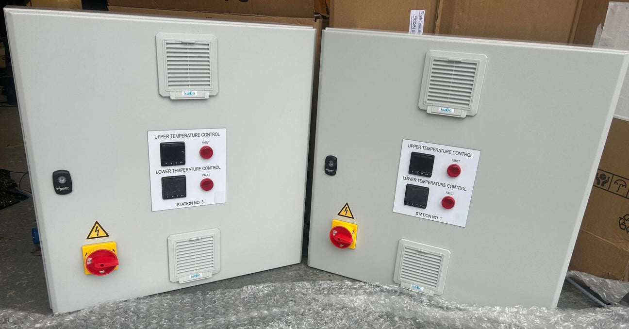 Two Production Automation control panels fitted with upper and lower PID temperature controllers, red indicator lamps, isolator switches and filter fans